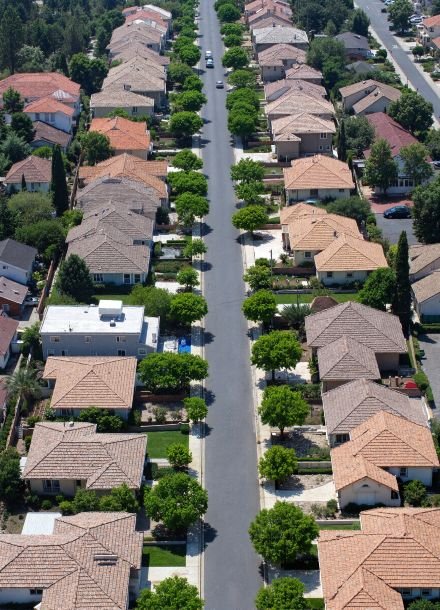 Aerial view of a suburban neighborhood in Sacramento with tree-lined streets and residential homes