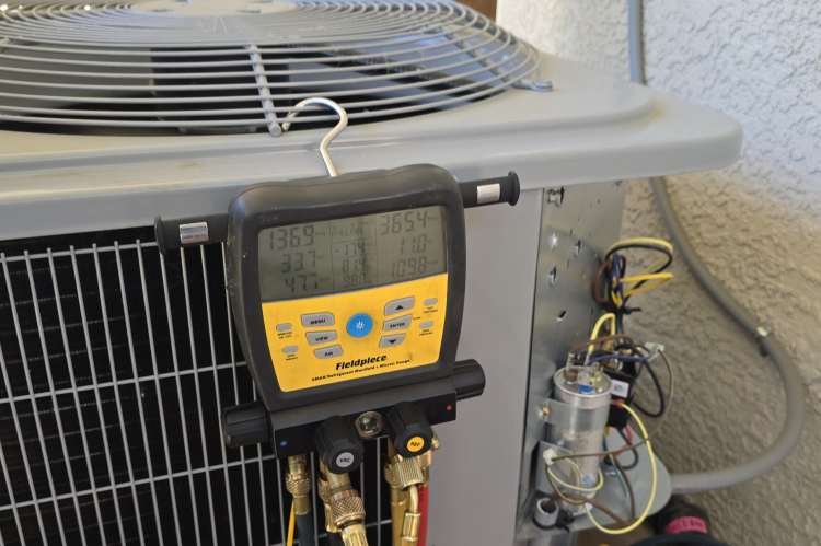Levano Pro HVAC Solutions technician checking refrigerant pressures on an outdoor HVAC unit in Sacramento