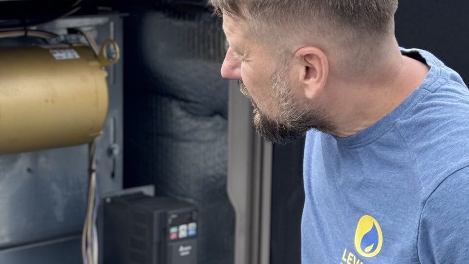 Levano Pro HVAC technician checking the blower section of an HVAC unit where the filter sits