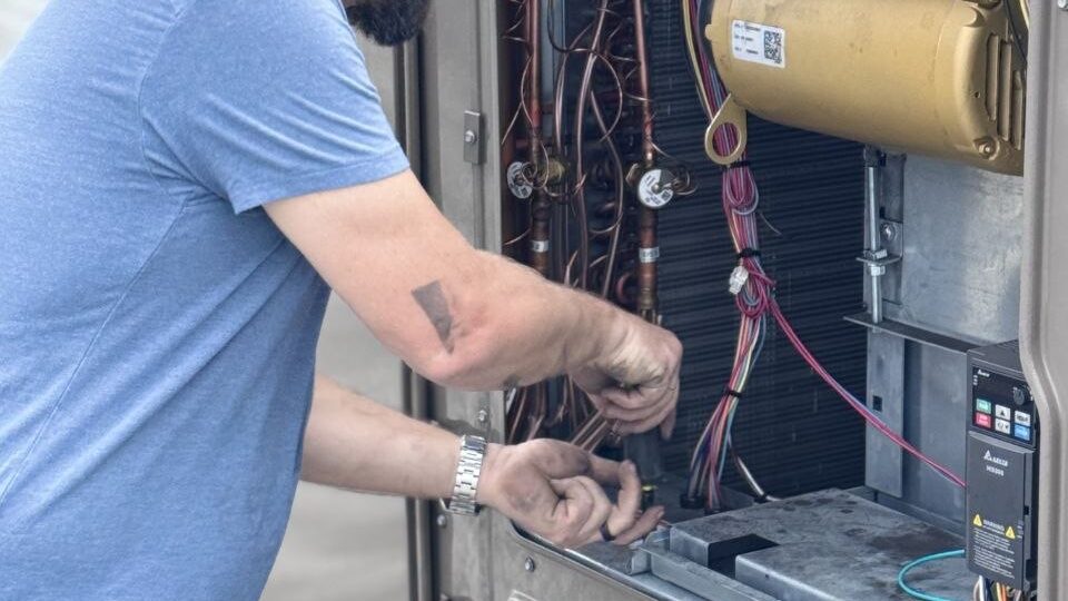 Levano Pro HVAC technician working on the refrigerant piping inside an HVAC unit