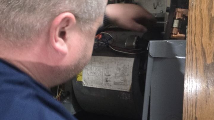 Levano Pro HVAC technician checking the blower motor and wiring inside a residential furnace