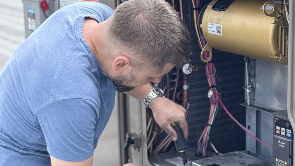 Levano Pro HVAC technician testing controls inside an open HVAC unit