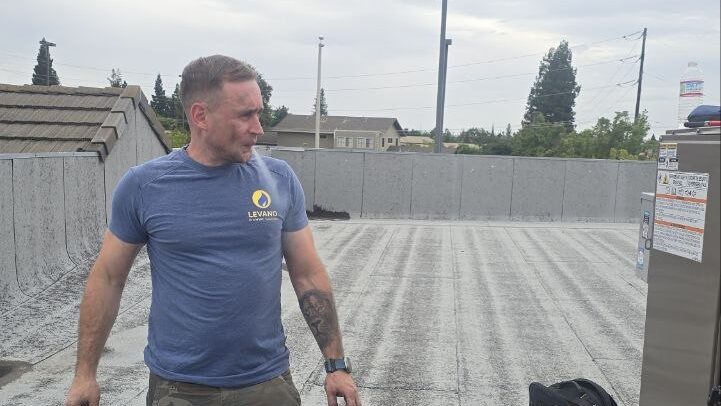 Levano Pro HVAC technician on a flat roof during a cooling service call