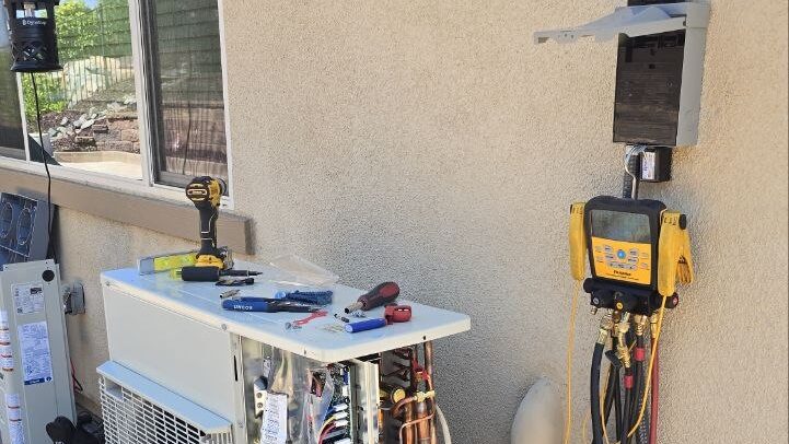 Heat pump outdoor unit mid-installation with manifold gauges connected, installed by Levano Pro HVAC in the Sacramento area