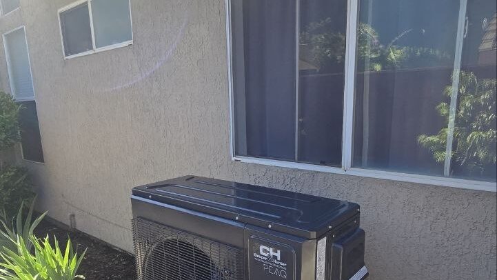 Heat pump outdoor unit installed under a window of a Sacramento-area home